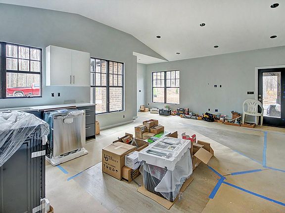 Another view of kitchen and living area with vaulted ceilings and an abundance of windows for lots of natural light.