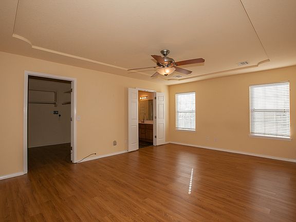 Master Bedroom on Rightside has wood floors. Has a walk in Seasonal Closet.