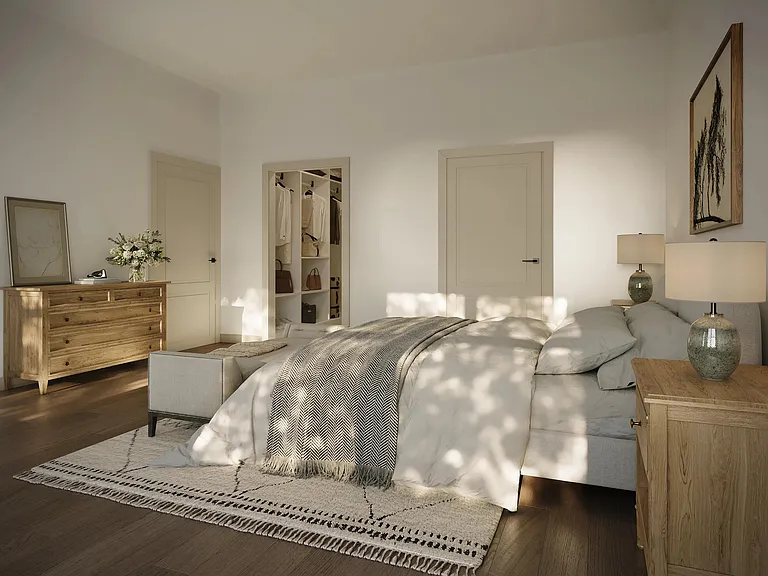 Primary bedroom with soft natural light, warm finishes, and a calm layout that supports rest and an easy start to the day.