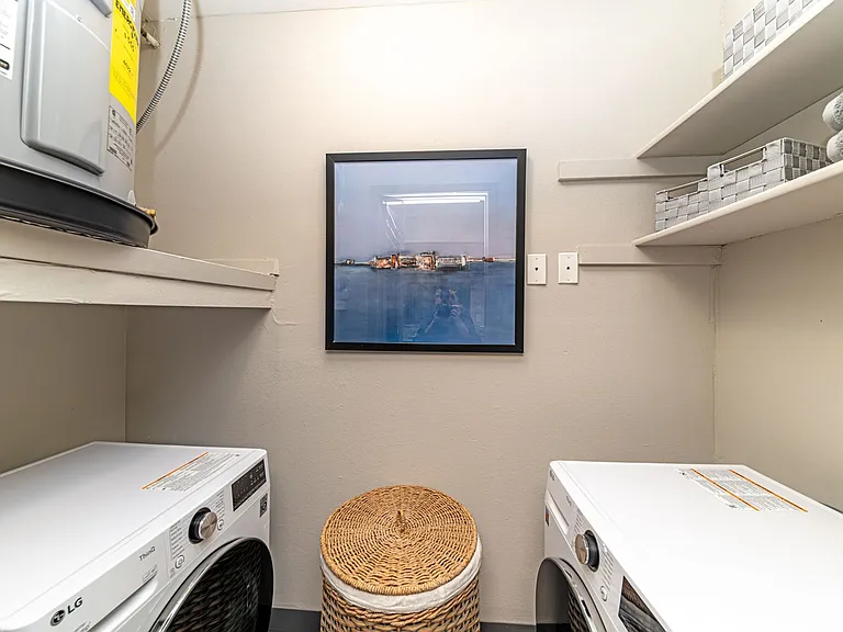Laundry room with built in shelving and storage
