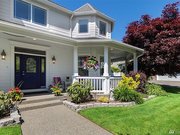 Front view of the wrap-around porch. To the left leads to one of two patios for this home.