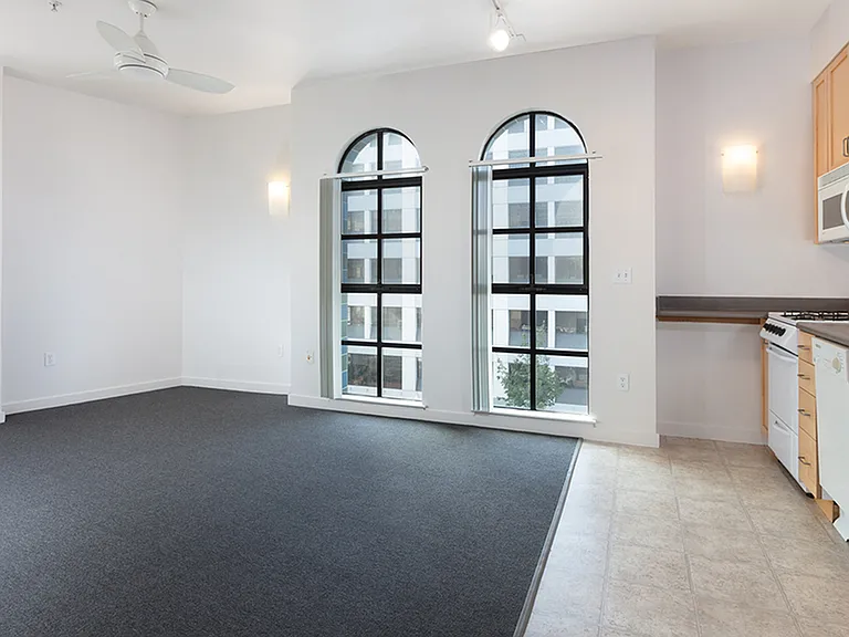 Living room and kitchen at Bachenheimer with oversized arched windows