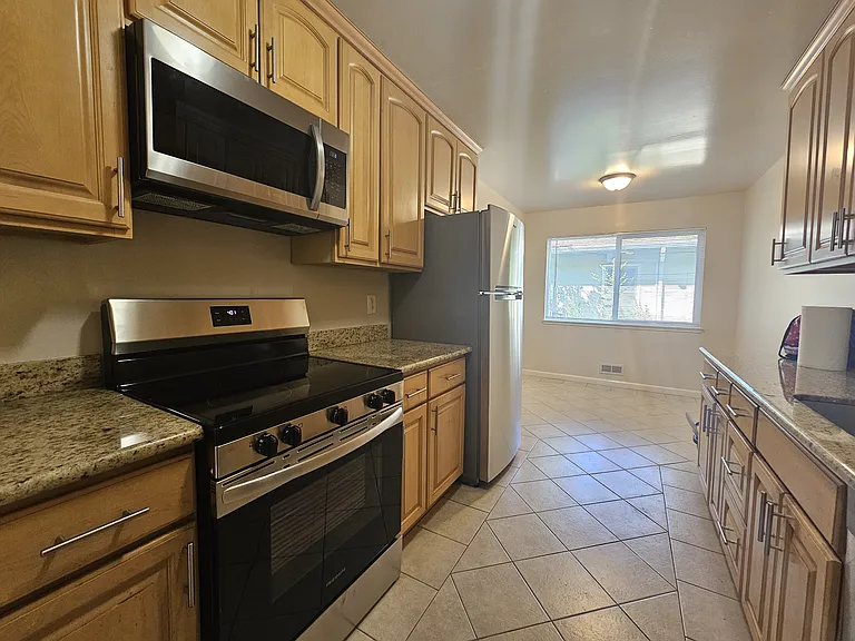 Kitchen - new stainless steel electric range, microwave oven and dishwasher