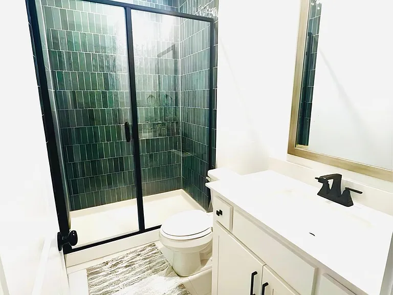 Guest Bathroom with vanity and a shower stall