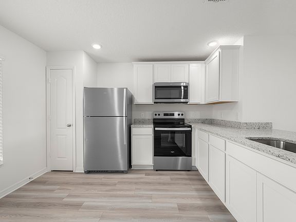 The kitchen comes chef ready with stainless steel appliances