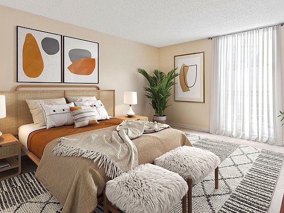 Elevate your living at Lakeshore Preserve with this beautifully designed bedroom featuring modern art and cozy furnishings. Enjoy a serene atmosphere and plenty of natural light. Schedule a tour today to find your perfect home.