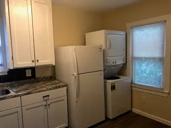 Kitchen area with washer dryer.
