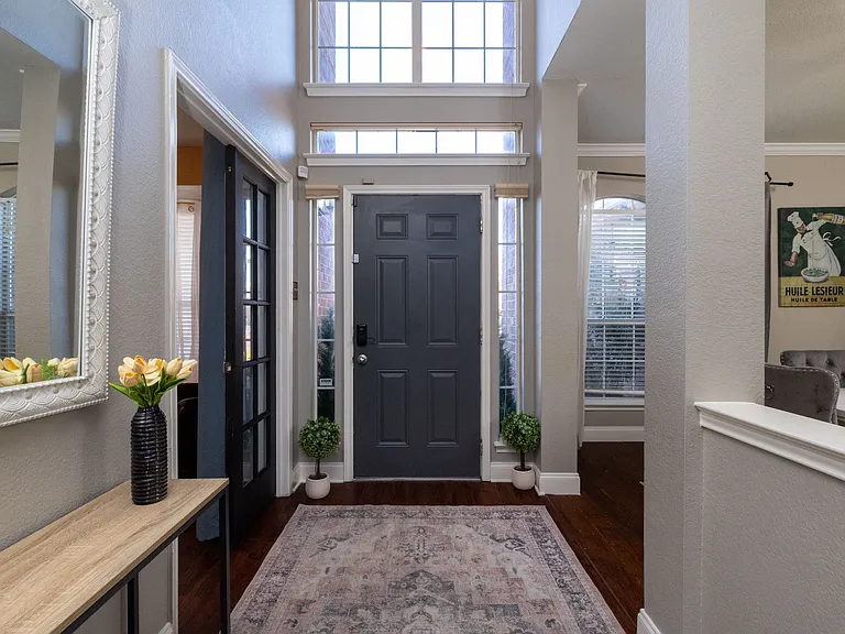 Inviting foyer with high ceilings and abundant natural light.