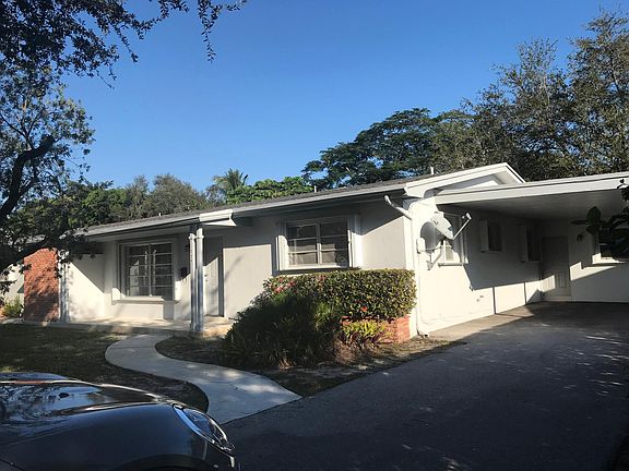 Front of home and covered carport.