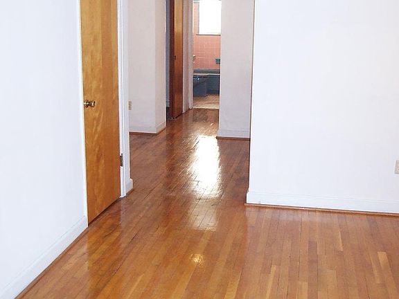 Living room through dinette area, hall with closet, and bath