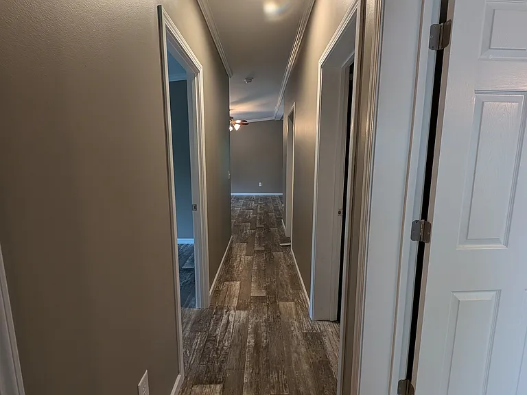 View from end of hallway towards living room and kitchen