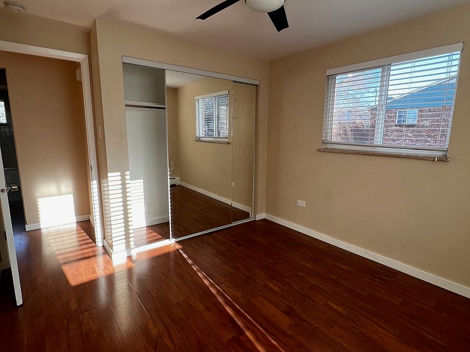 Bedroom with mirrored closets with lots of space and LED lit fan