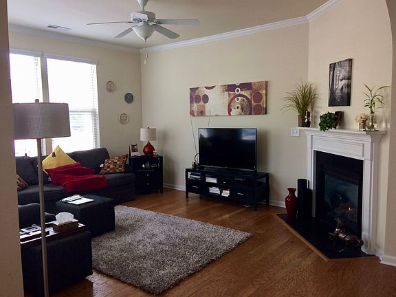 Living room -east wall w/windows, light-fan, Gas fireplace. Adjacent is guest coat closet.