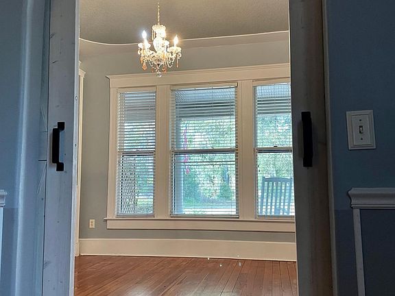 2nd bedroom or office with barn doors and beautiful chandelier