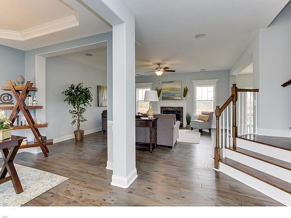 Foyer looking into dining room and great room. Photo similar to home being built
