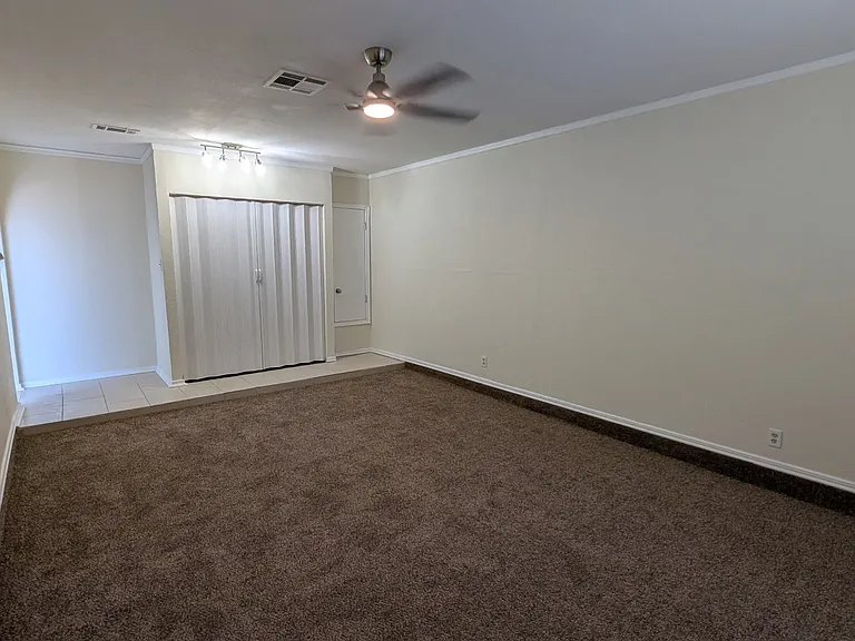 Living area/Den, with fold away doors that hide washer/dryer.