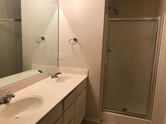 Double sink vanity, shower and garden tub in the master bath.