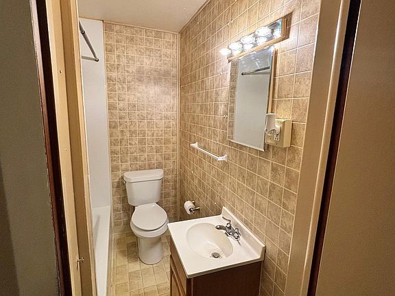 bathroom with tub and shower