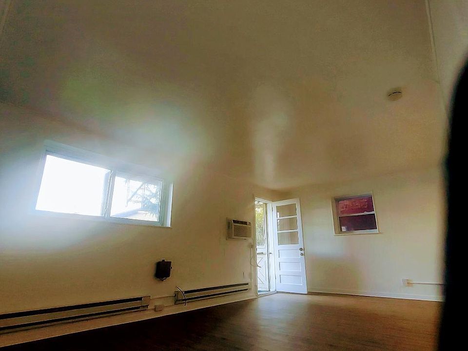 12x20 open living/bedroom area with 2 windows, new floors and door/screen door to 20x25 private back yard/outdoor living space. Wall AC, wall and baseboard separate heat.