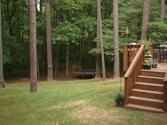 Large backyard, with beautiful deck, overlooks wooded area.  
