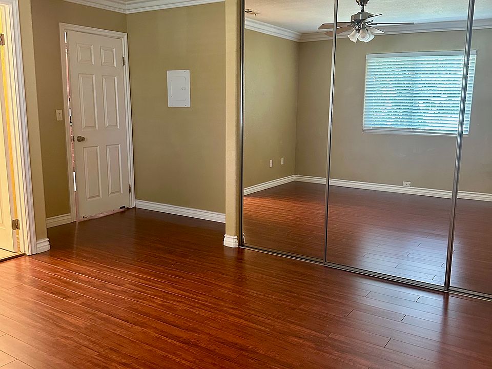 Main bedroom with wall to wall closet and ceiling fan light.