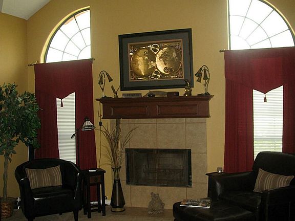 FORMAL LIVING AREAS AS YOU ENTER WITH HIGH CEILING,GAS FIREPLACE, CUSTOM PAINT & UNIQUE WINDOWS.