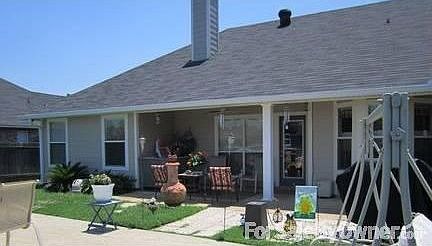 Back View : Two patios, covered with outdoor ceiling fan and stamped patio