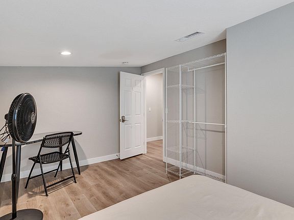 Room 8, floor fan, wardrobe, looking out to hallway