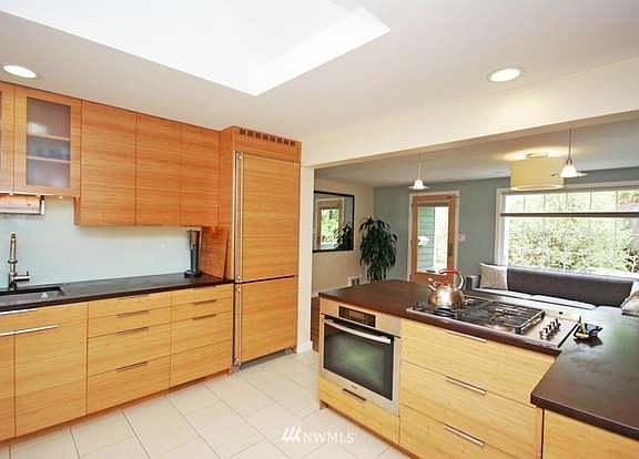 Kitchen, with bamboo-faced drawers, cabinets and refrigerator.