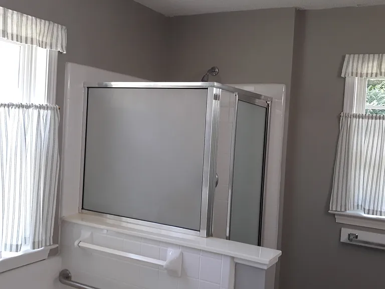 Privacy glass on shower. Garden tub for soaking, complete with grab bar.