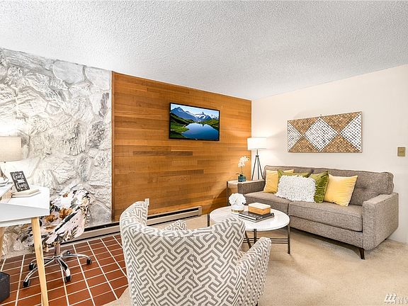 Living room provides space for visiting and a computer area.