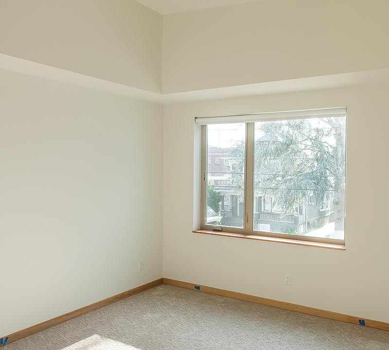 Bedroom 1 (south facing): high ceiling and picture window.
