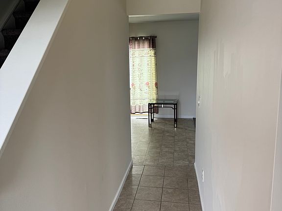 Front hallway leads right to kitchen