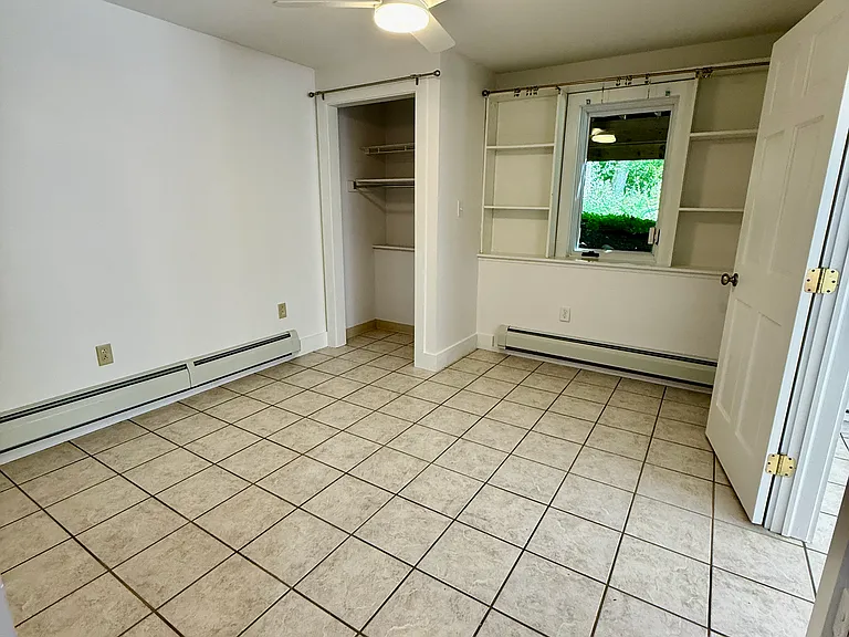 Bedroom with closet, built-in bookshelves for office facing the woods. Fits a queen size bed.