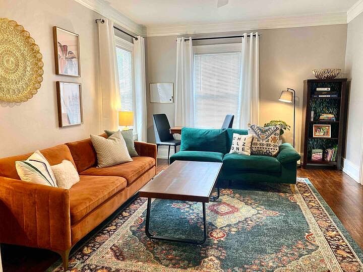Plenty of seating in the Family Room, with a game/ office table behind the green couch.