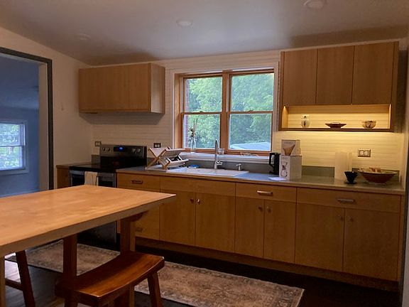 Remodeled kitchen with custom cabinetry, new appliances, repainted walls and refinished floors