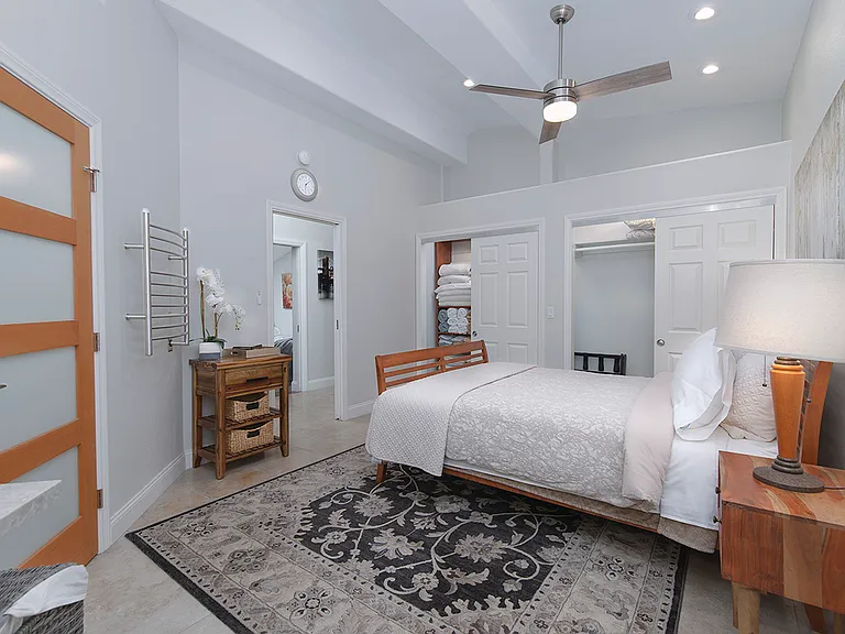 The primary bedroom has a lighted full wall closet for storage, as well as loft storage space above. The closet has a built-in organizer for linens and extra pillows.