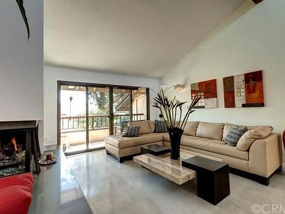 Living room area with fireplace and balcony