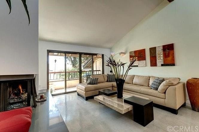 Living room area with fireplace and balcony