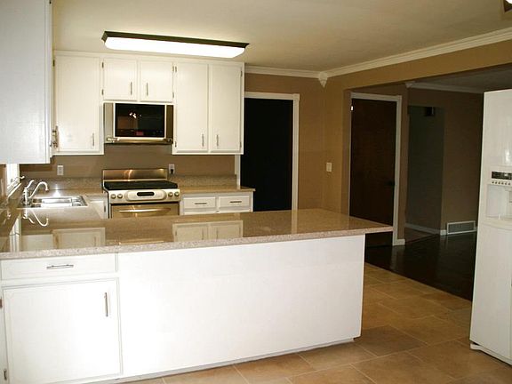 Here is another view of the kitchen. Slider off the kitchen to the deck of the backyard. Nice size yard for family and friends.