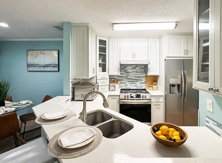 Bright kitchen with custom cabinetry. Solid surface countertop.