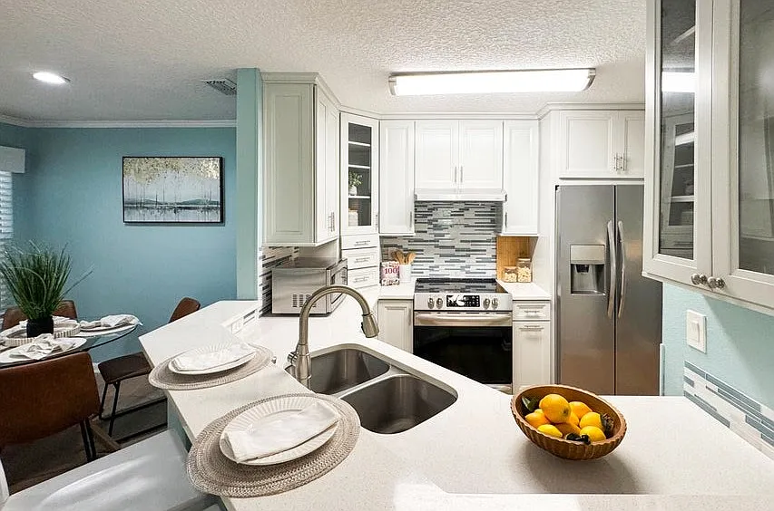 Bright kitchen with custom cabinetry. Solid surface countertop.