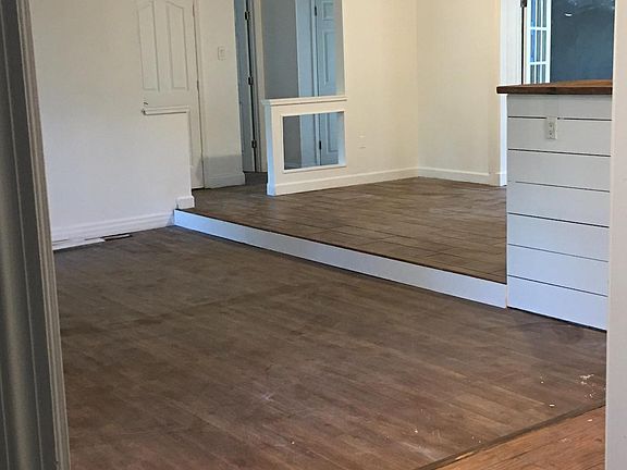 From front entry way across living and dining area towards 2 bedrooms and bathroom and 2 hall closets