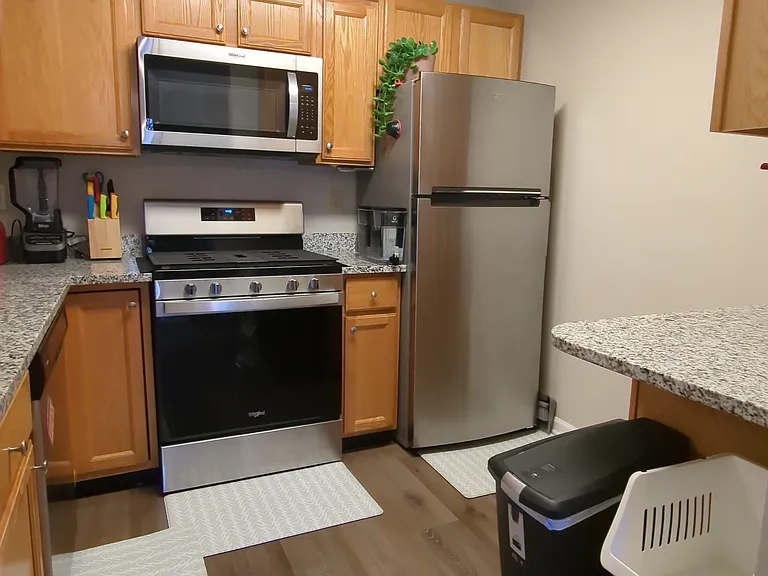 Full kitchen with dishwasher, stove, refrigerator, oven, microwave & ample cabinet and counter space
