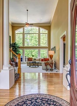 2 Story Entry Foyer Opens to Palladian Window Wall and Soaring Great Room Ceiling