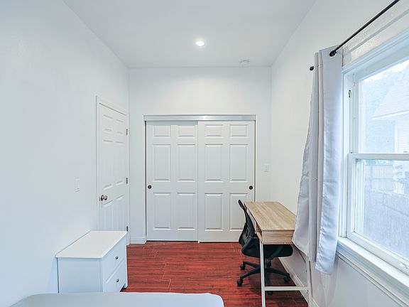 Bedroom 2 showing closet, desk, chair, and window