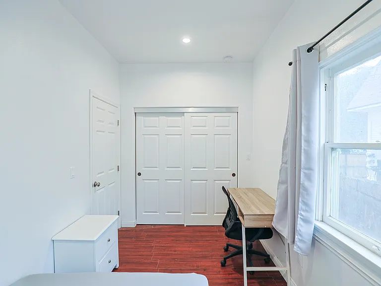 Bedroom 2 showing closet, desk, chair, and window