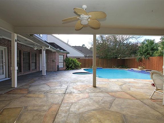 Here's another view of the Covered Patio showing it's also covered off the doorway to the utility/half bath and a door to the master suite extra room too! It's a must see to fully appreciate.