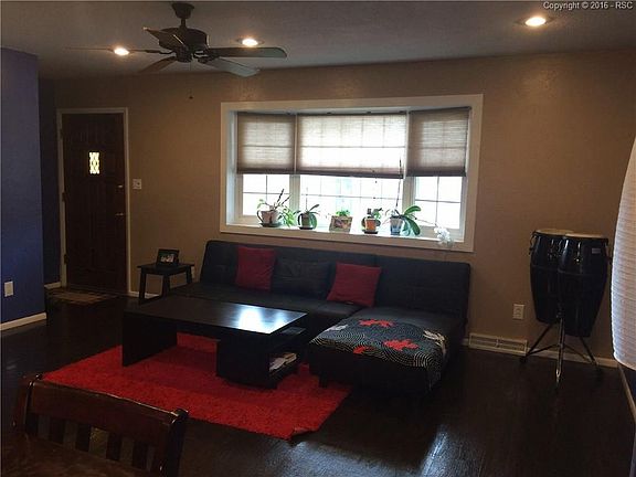 Front door and main level living room. Note can lights and bay window.