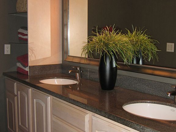 Granite slab and maple cabinets in bathrooms too!